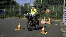 Mädchen auf einem Fahrrad, das einen Fahrradparcours absolviert 